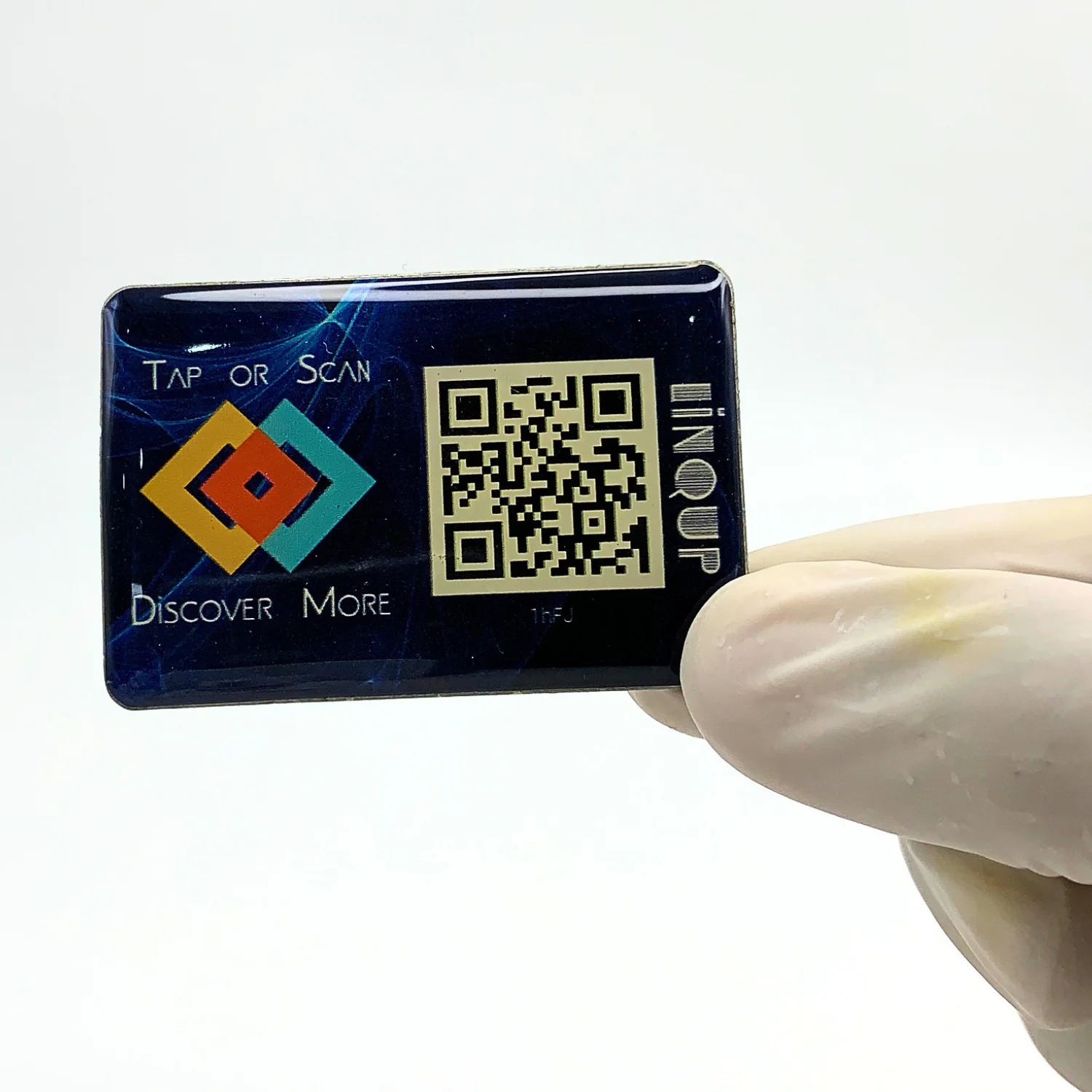 LINQS Smart NFC and QR dynamic sticker held by hand, showing glossy epoxy dome finish