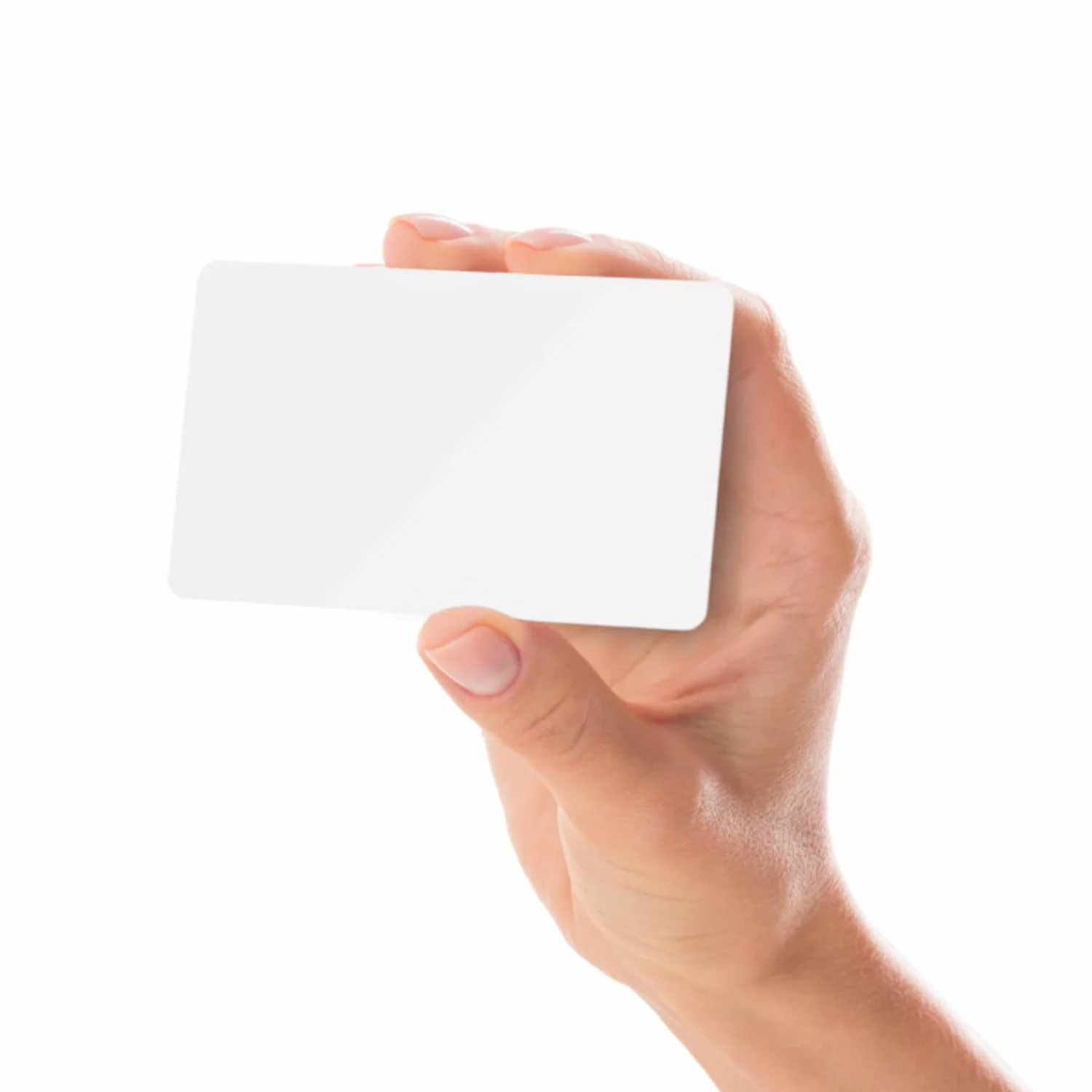 A hand holding a blank white PVC card against a plain white background.